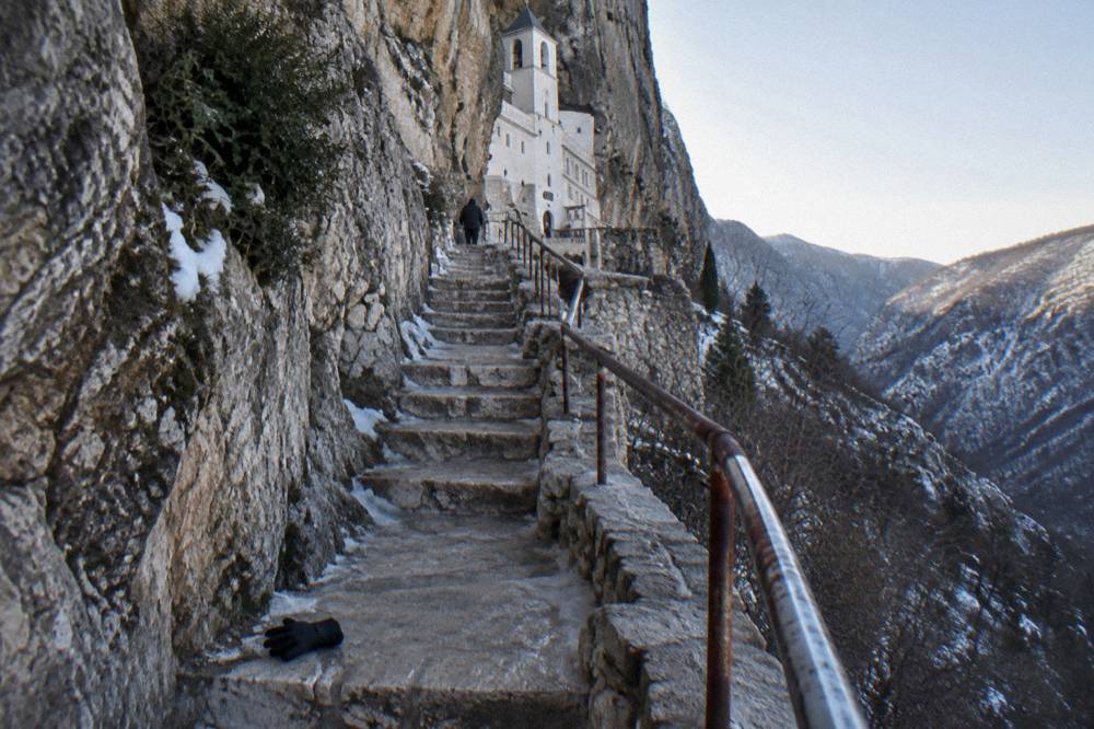 Narrow stone stairway leading up toward monastery buildings cut into the cliff