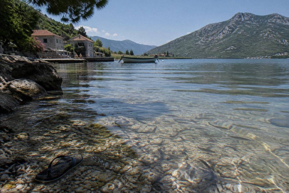 Quiet bay on Lake Skadar with clear shallow water over a pebbly bottom