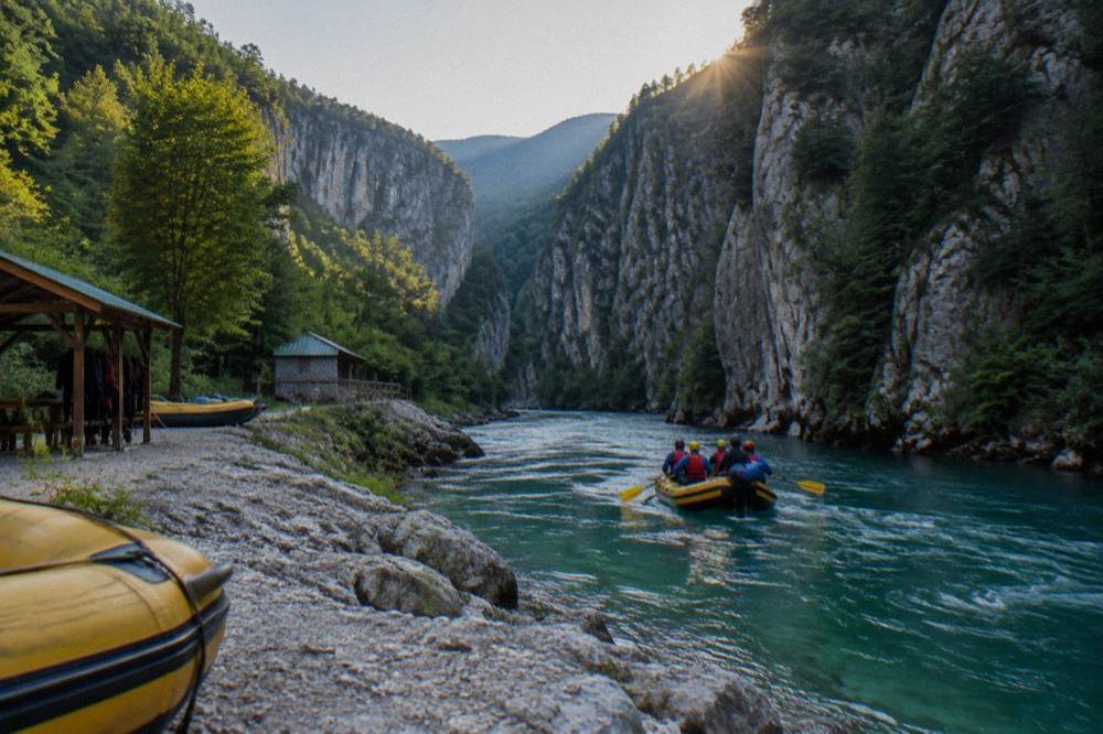 Raft floating on emerald river water between steep canyon walls