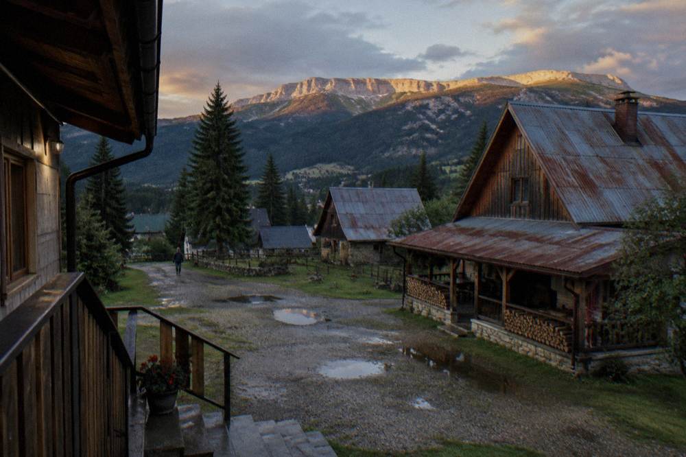 Small mountain town of Zabljak with wooden chalets under a high plateau skyline