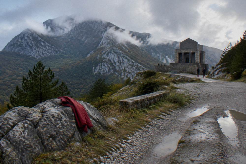 Mountain road viewpoint over Lovcen national park with stone peaks and forest