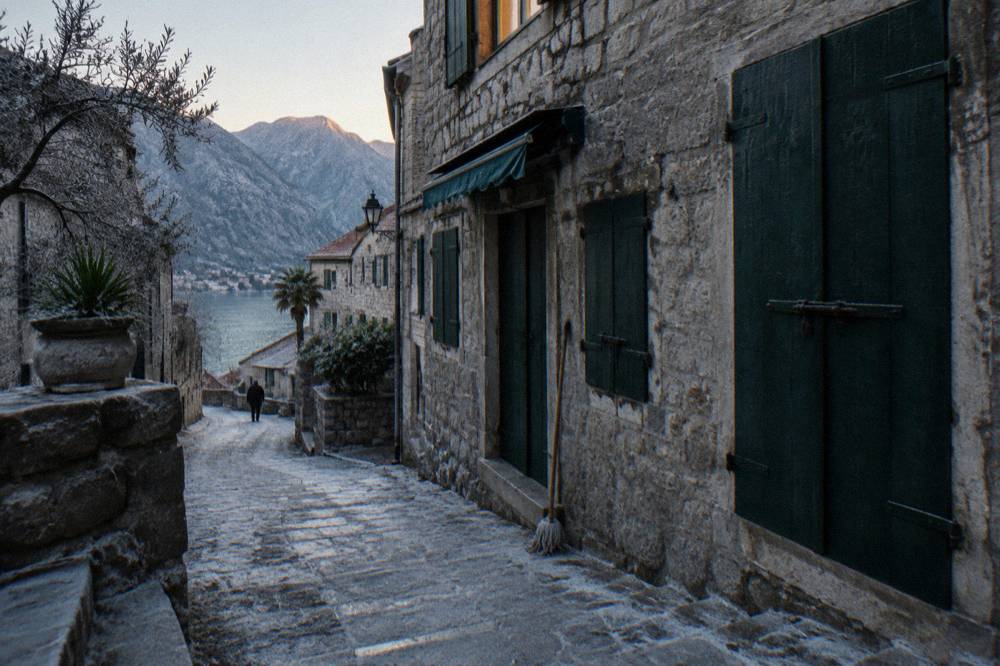 Narrow stone lane with old shutters inside Kotor old town