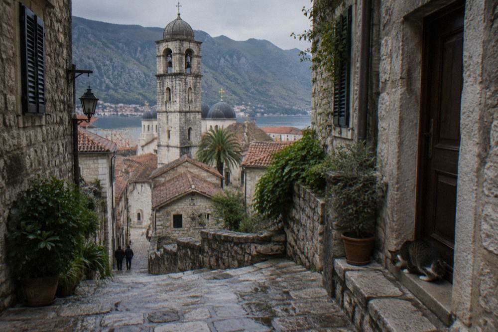 Stone stairs and narrow lane inside Kotor old town with old church towers