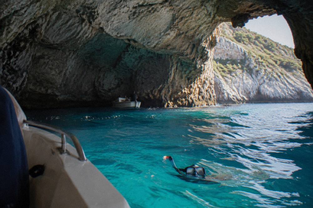 Turquoise water and rocky cliffs at the entrance to a sea cave on the Montenegrin coast
