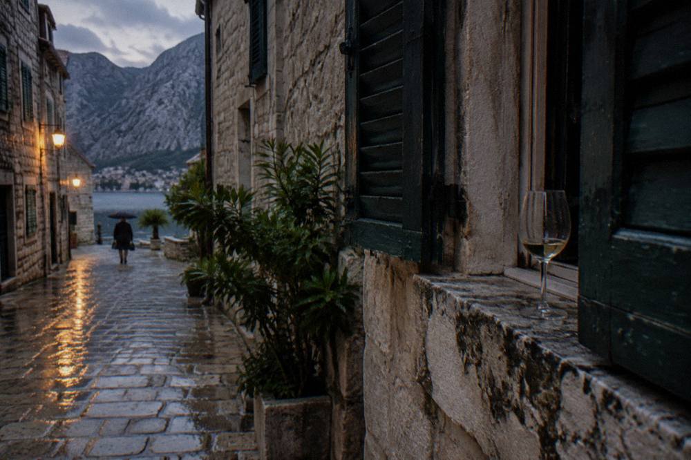 A narrow stone street in Kotor Old Town with shuttered stone buildings