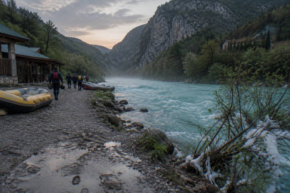 A turquoise mountain river flowing between steep forested canyon walls