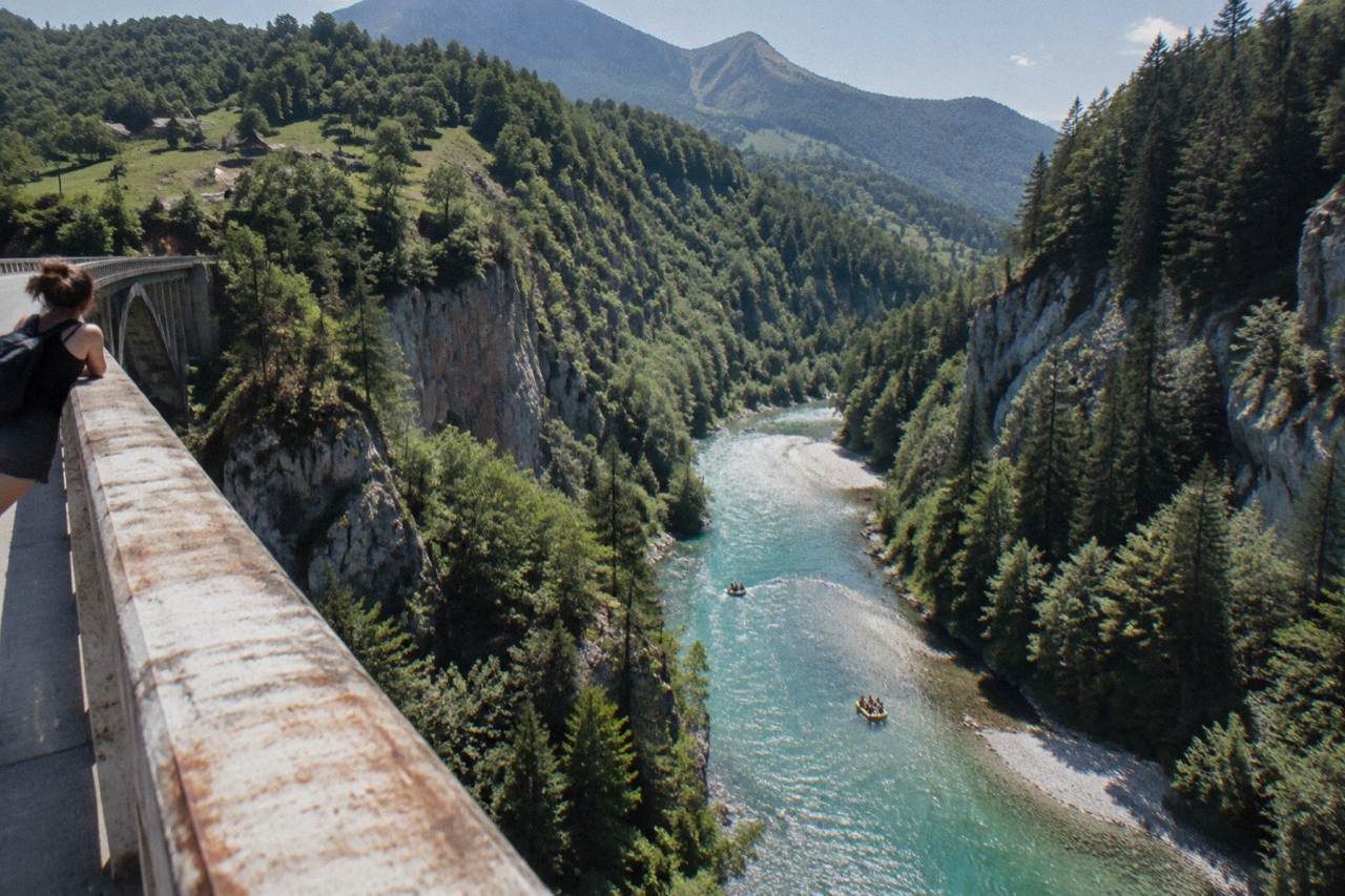 A turquoise mountain river flowing between steep forested canyon walls