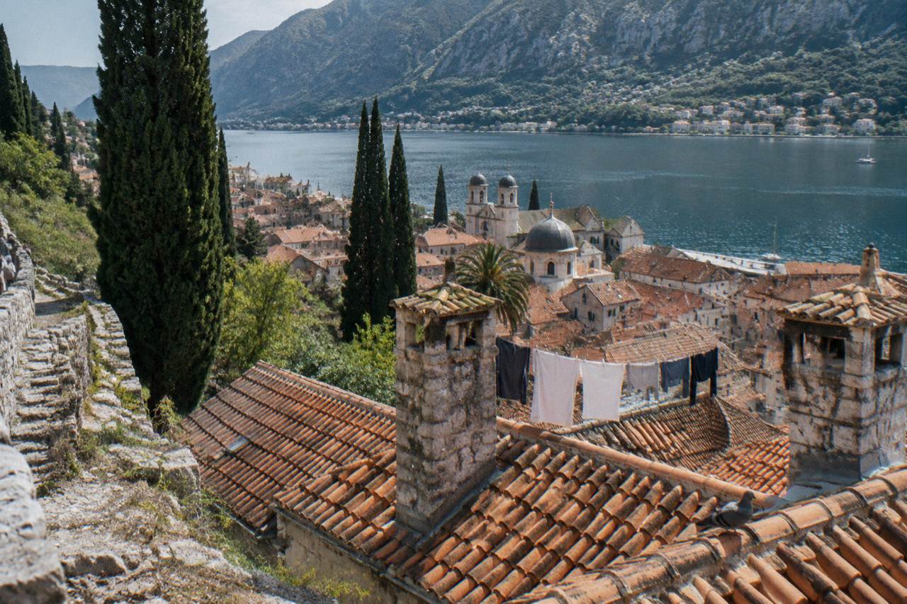 Terracotta rooftops of Kotor Old Town below the hillside walls on a clear morning